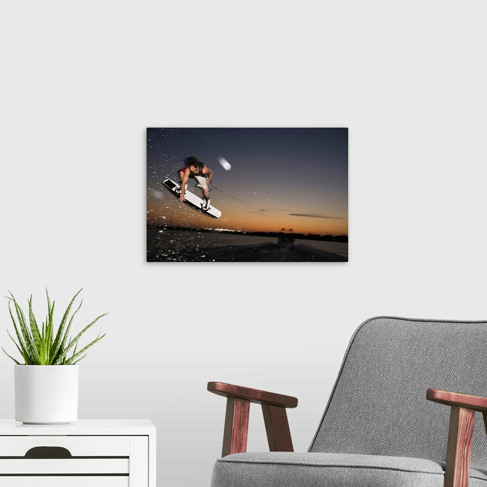 A modern room featuring Midair wakeboarder at sunset