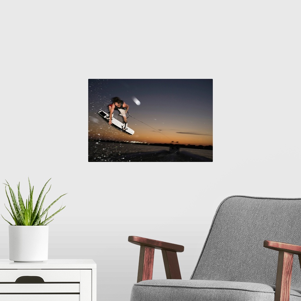 A modern room featuring Midair wakeboarder at sunset