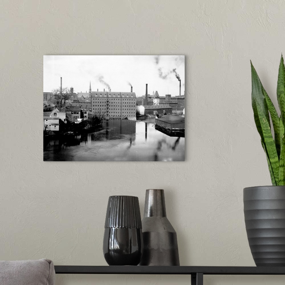 A modern room featuring Mills and smokestacks line the Merrimack River in Lowell, Massachusetts.