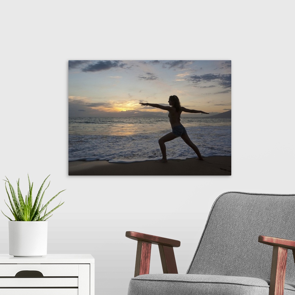 A modern room featuring Mixed race woman practicing yoga on beach