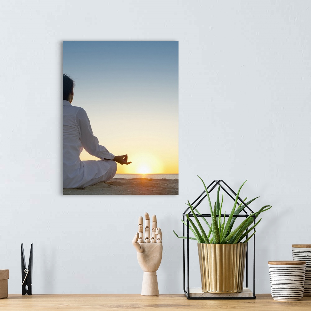 A bohemian room featuring Mixed race woman practicing yoga on beach