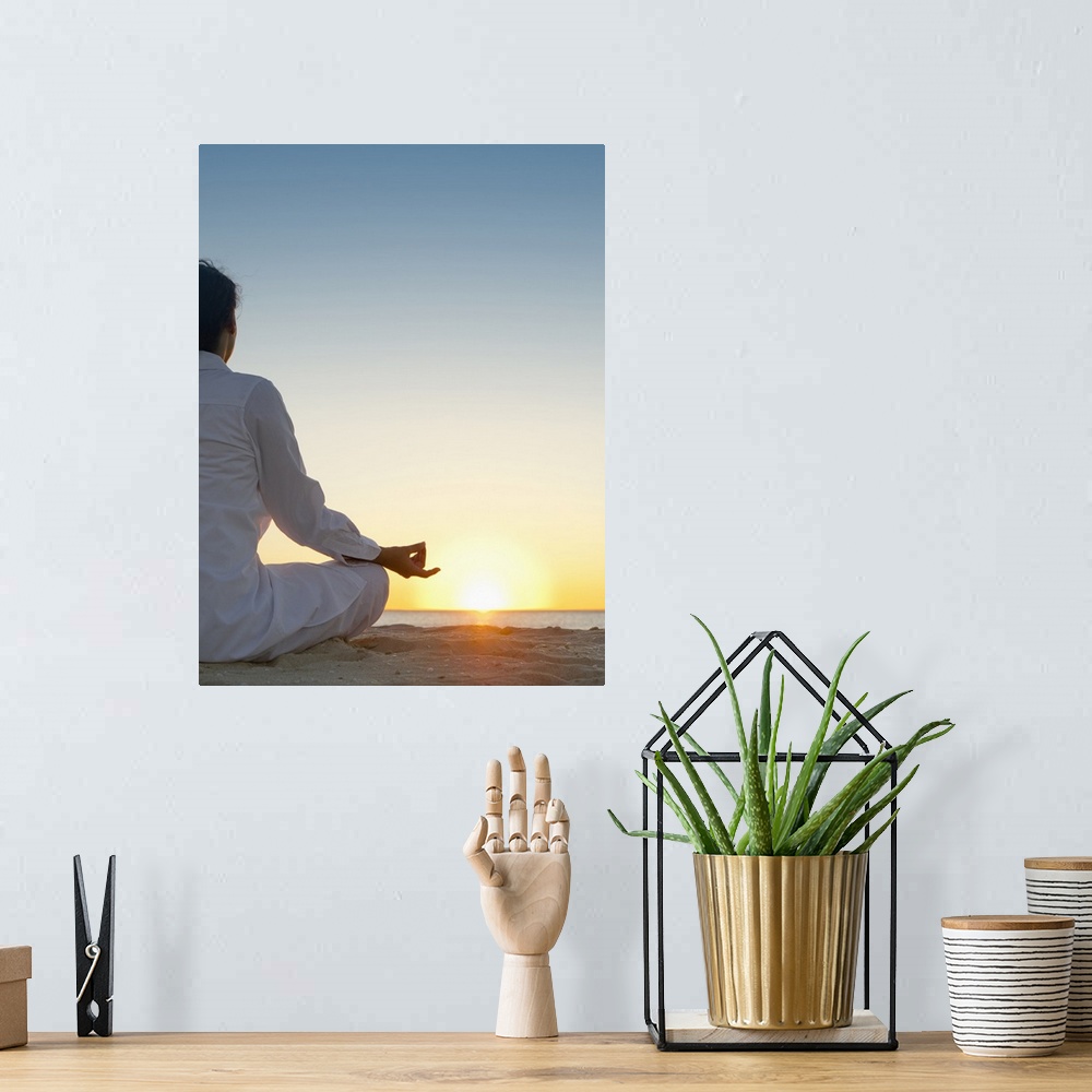 A bohemian room featuring Mixed race woman practicing yoga on beach