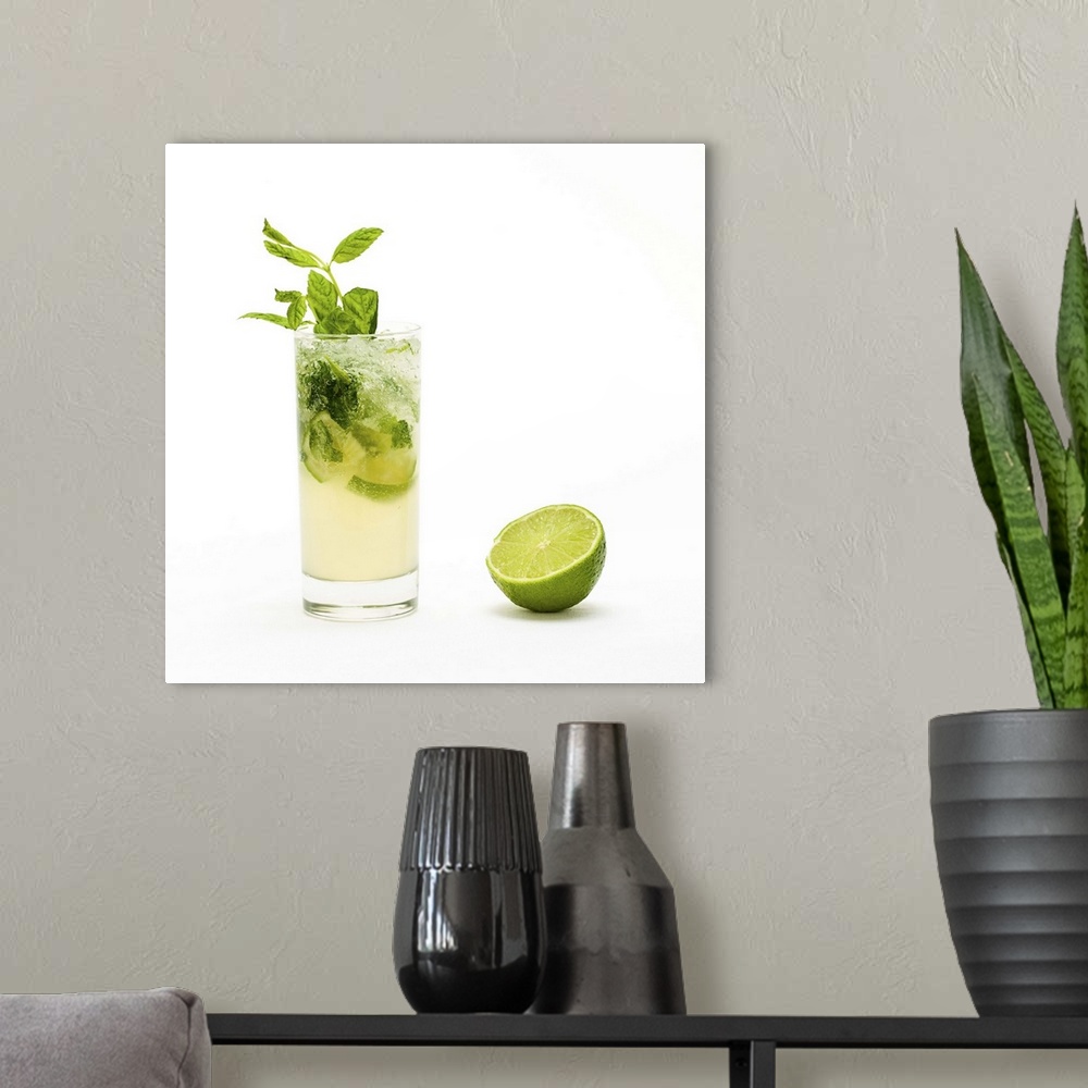 A modern room featuring Mojito with fresh mint leaves and lime on crushed ice