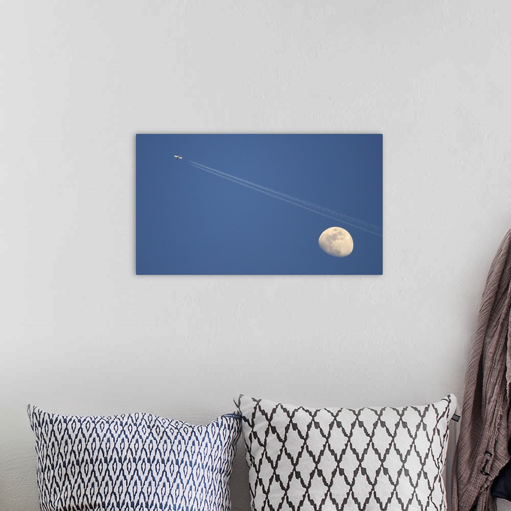 A bohemian room featuring Moon and airplane in sky.
