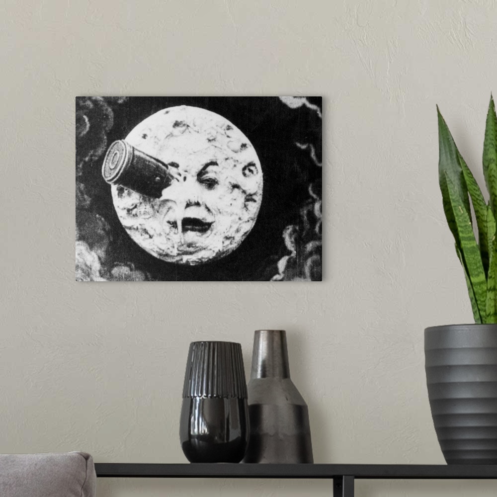 A modern room featuring Depiction of Man in the Moon with a rocket in his eye from the 1914 silent animated film A Trip t...