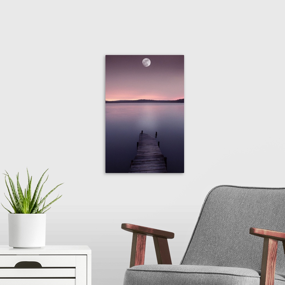 A modern room featuring Moon over lake with pier at dusk
