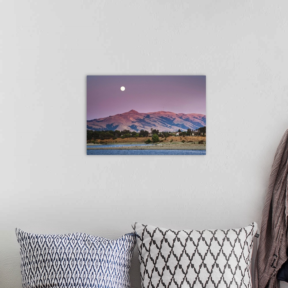A bohemian room featuring Moonrise Over Mission peak California at sunset time.