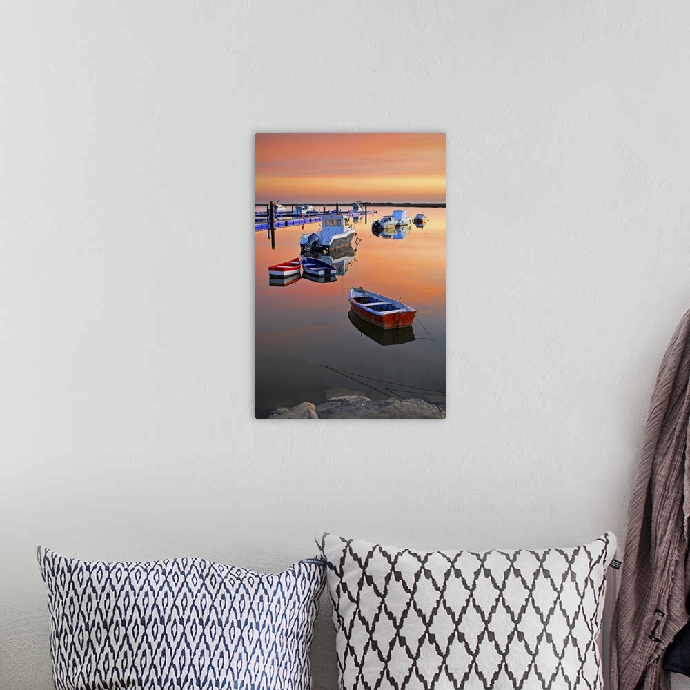 A bohemian room featuring Moored boats on sea at sunset.