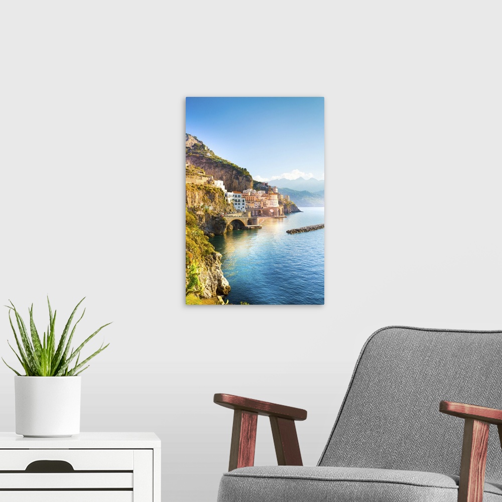A modern room featuring Morning view of Amalfi cityscape on coast line of mediterranean sea, Italy.