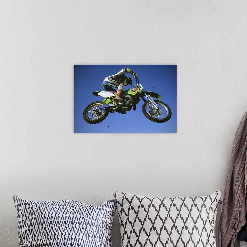 A bohemian room featuring Motocross Bike & Rider Shot From Below As They Fly Though The Air