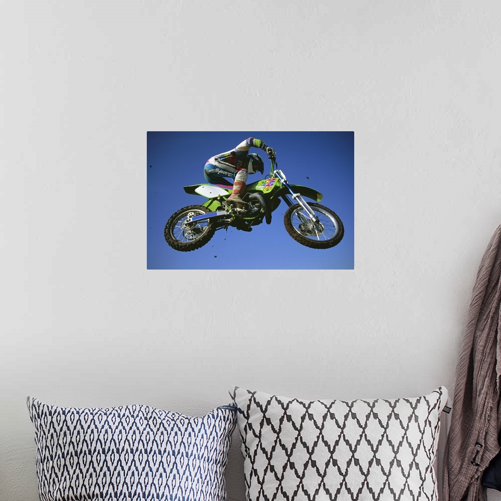 A bohemian room featuring Motocross Bike & Rider Shot From Below As They Fly Though The Air