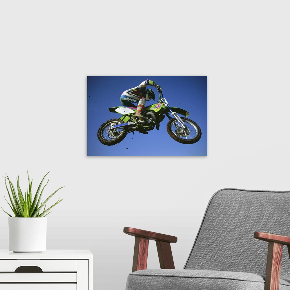 A modern room featuring Motocross Bike & Rider Shot From Below As They Fly Though The Air