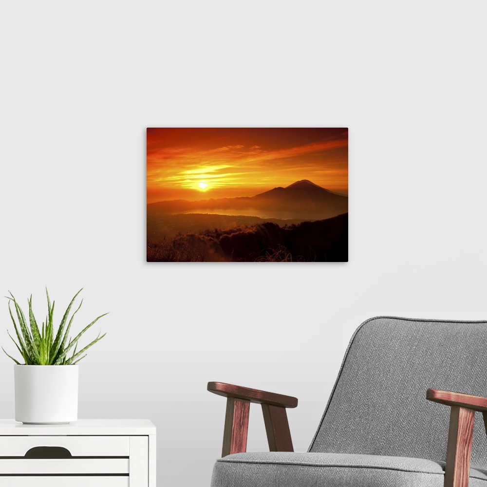 A modern room featuring Mount Batur with Danau Batur during sunrise.