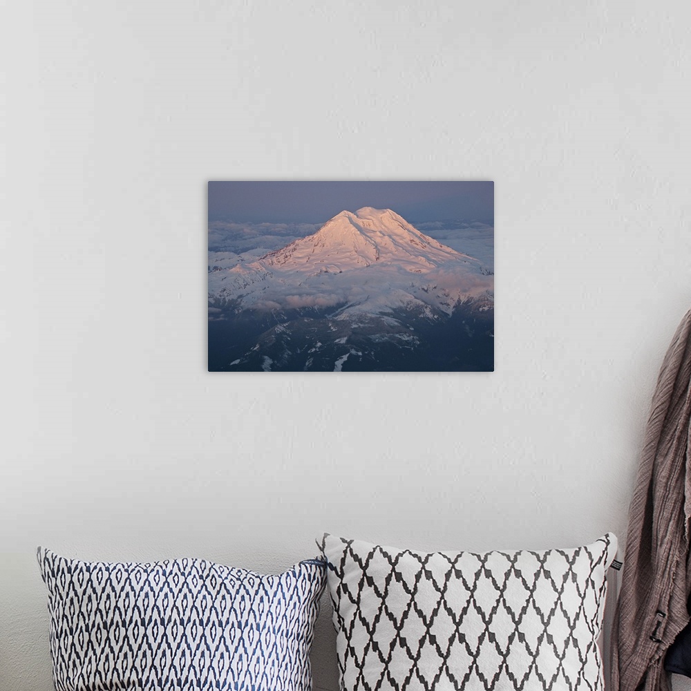 A bohemian room featuring Landscape, aerial photograph of a snow covered Mount Rainier, surrounded by clouds, a dark sky in...