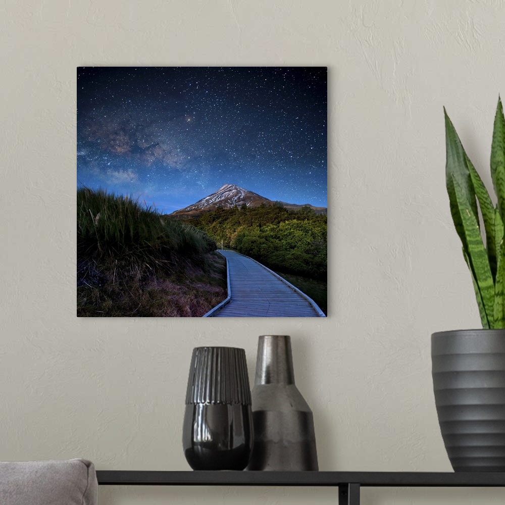 A modern room featuring Mt. Ekmond at night with star light.