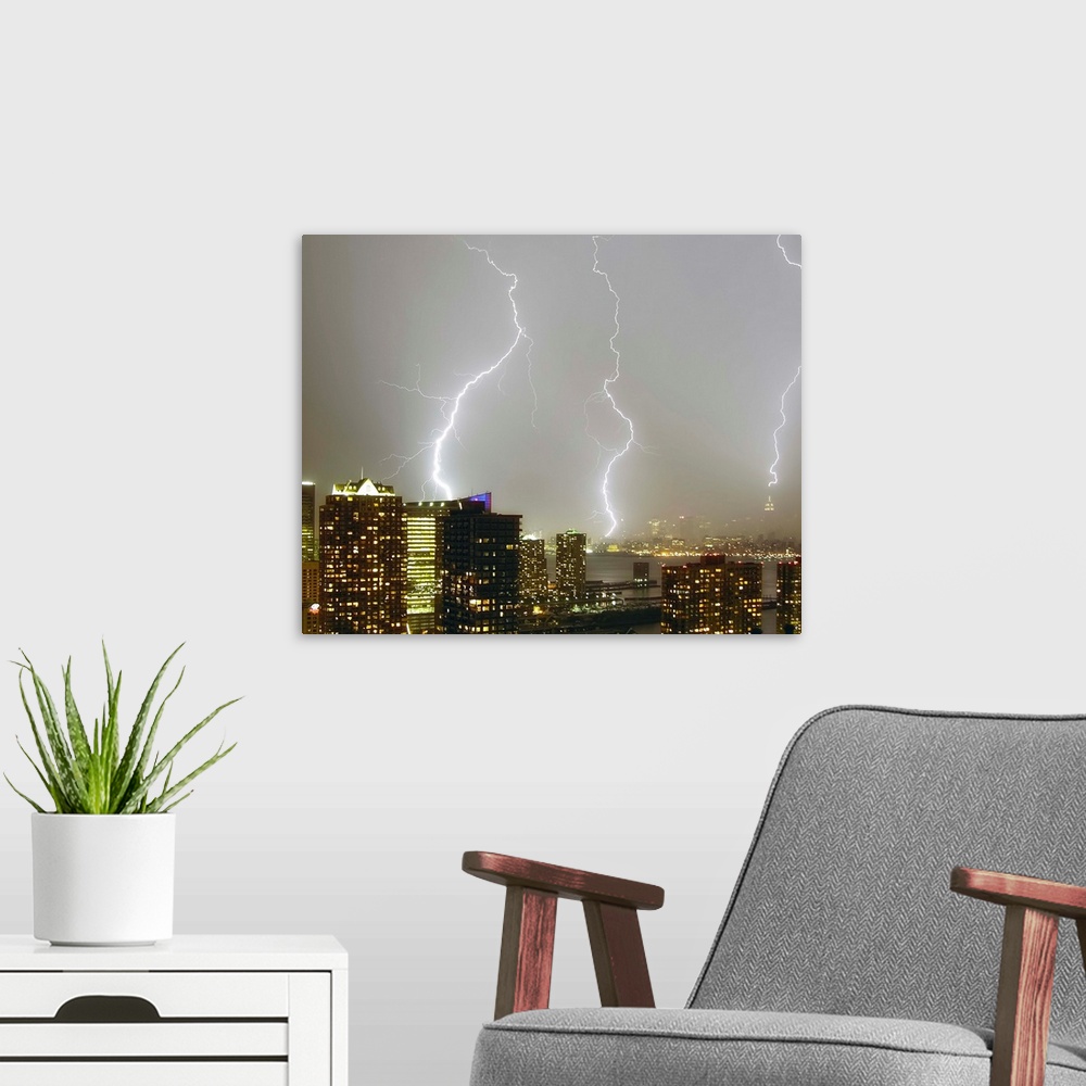 A modern room featuring Multiple dramatic lightning strikes viewed from Jersey City, New Jersey looking towards New York ...