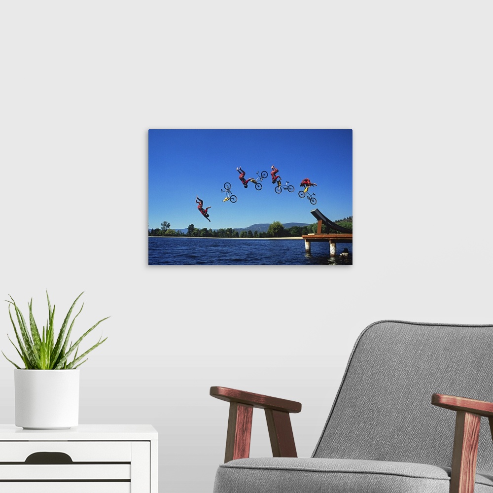 A modern room featuring Multiple exposure of cyclist going off jump into water