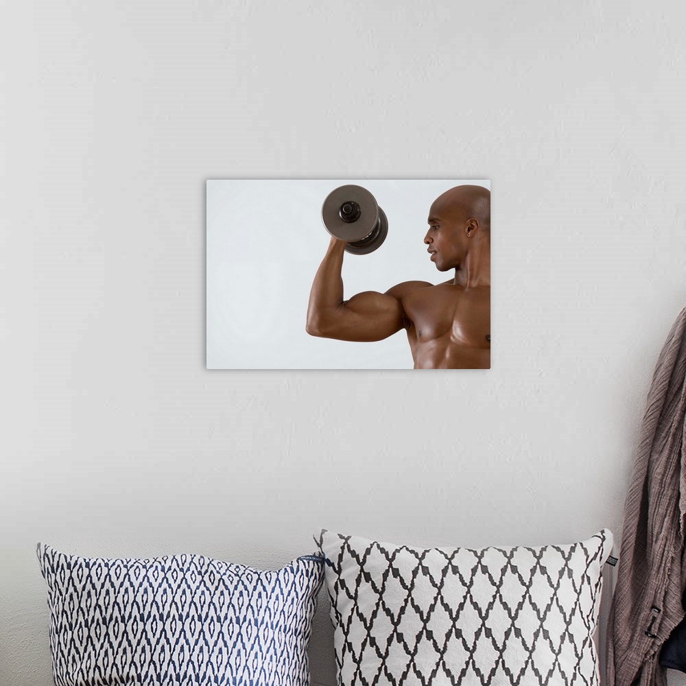A bohemian room featuring Muscular man lifting dumbbell