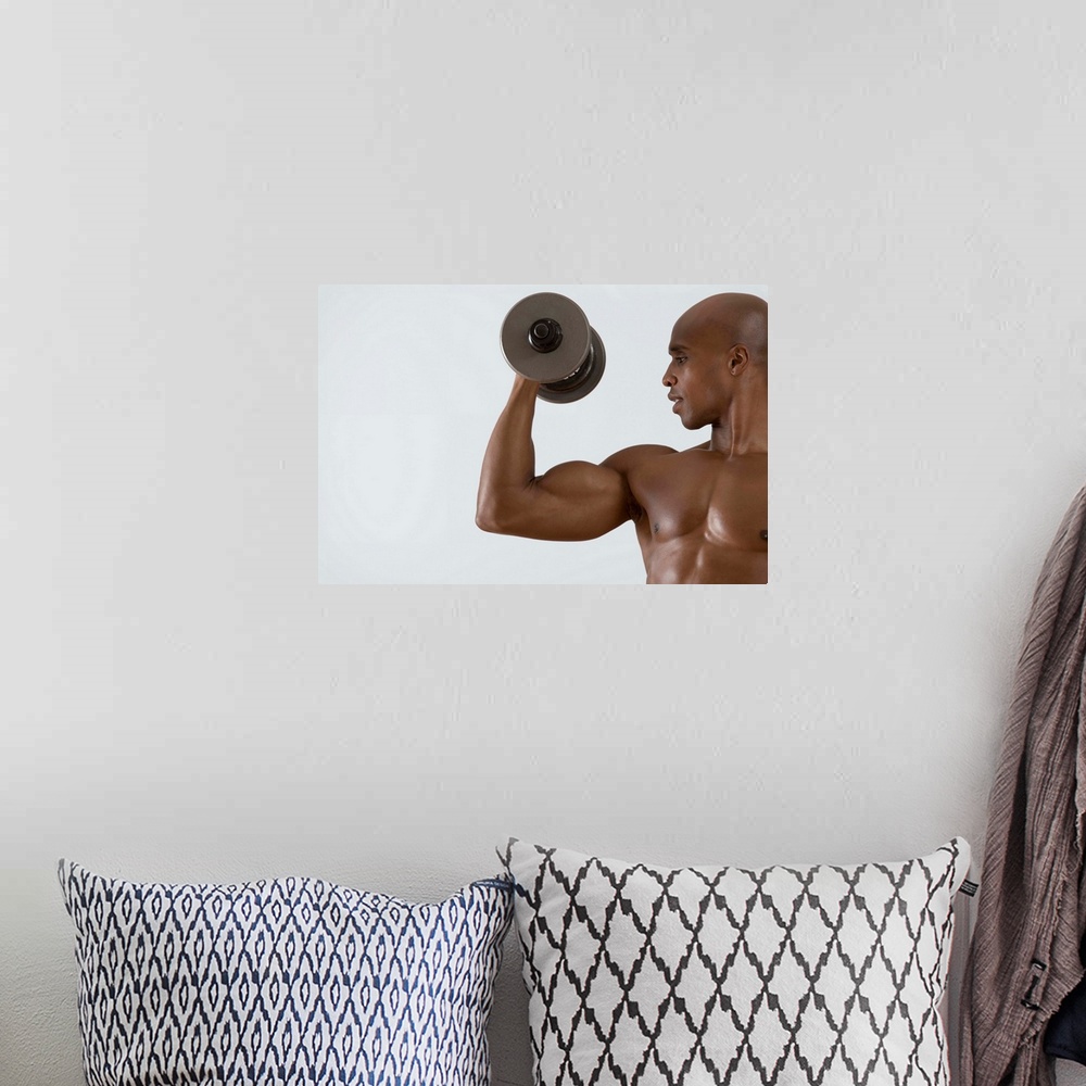 A bohemian room featuring Muscular man lifting dumbbell