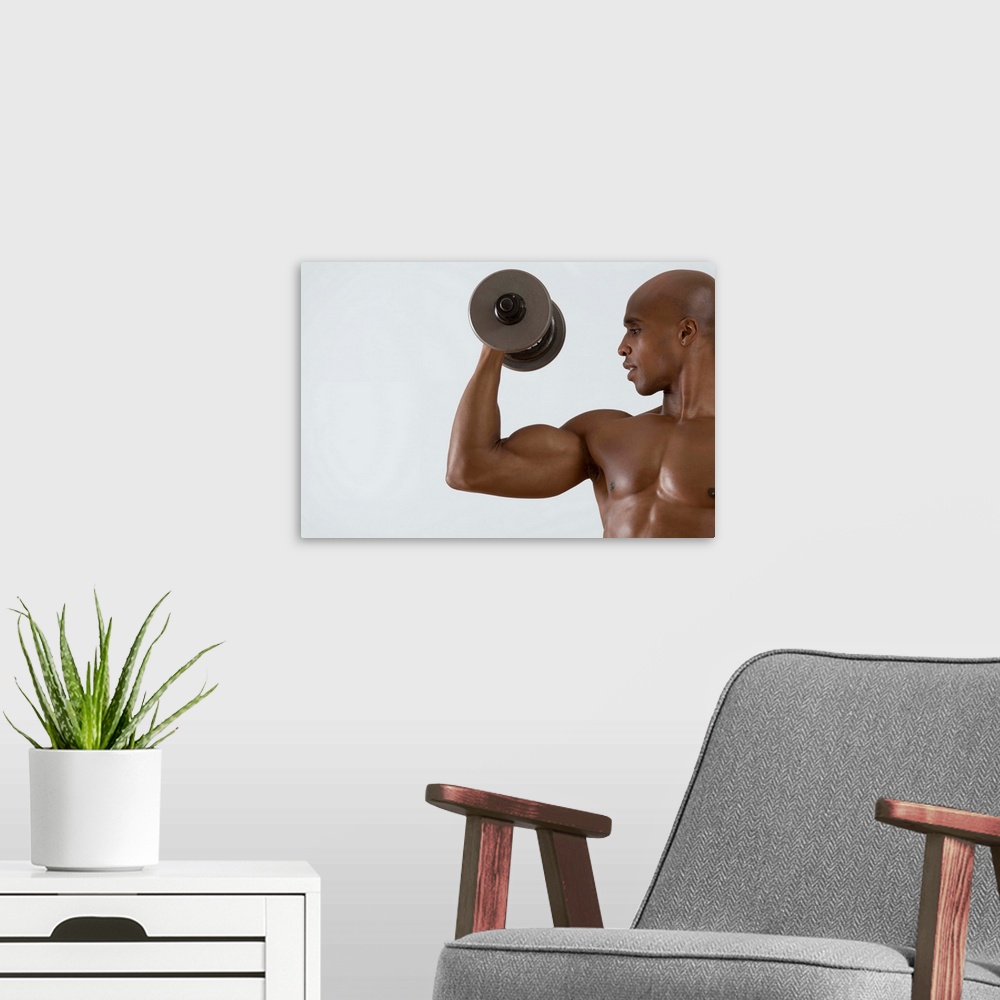 A modern room featuring Muscular man lifting dumbbell