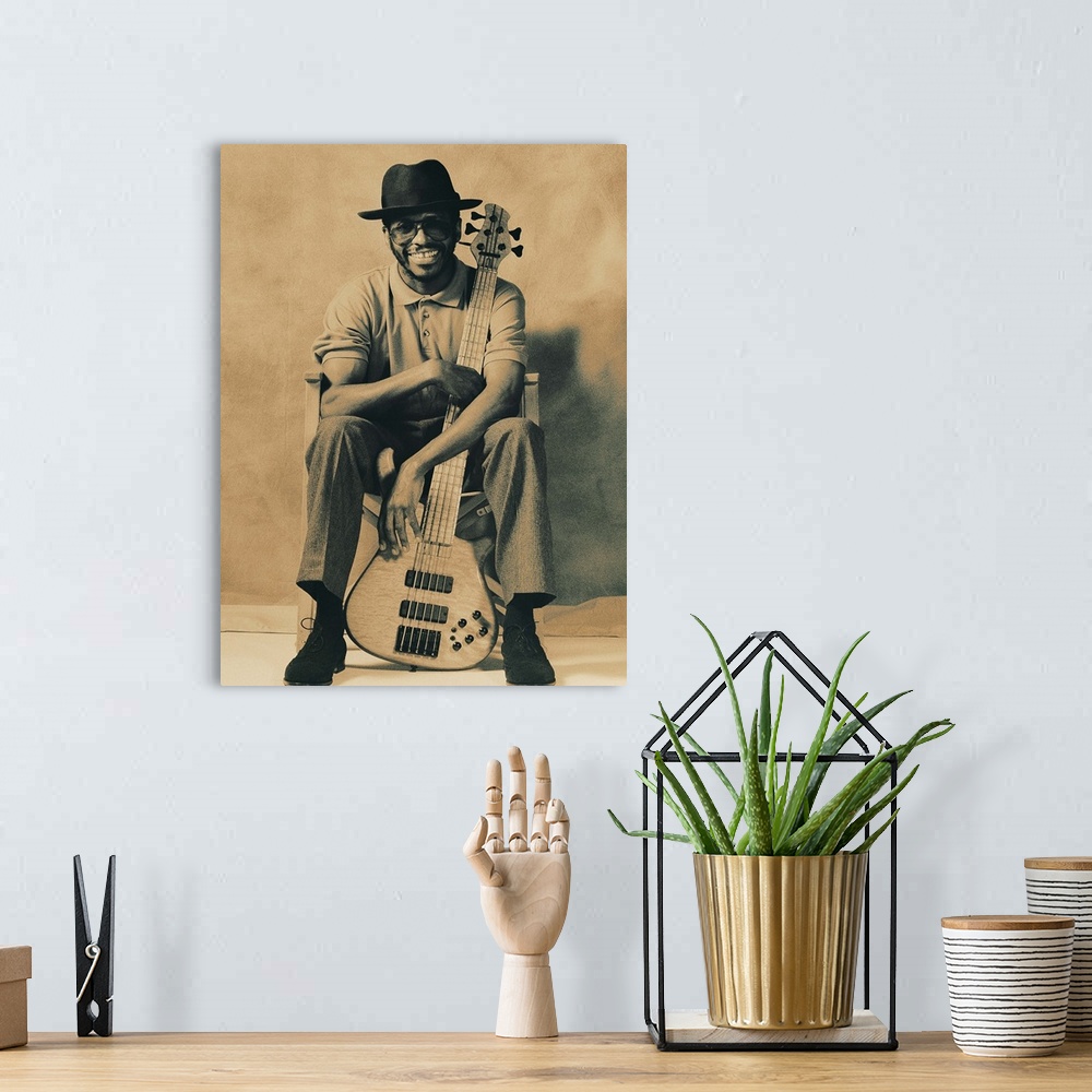 A bohemian room featuring Musician with arms wrapped around guitar