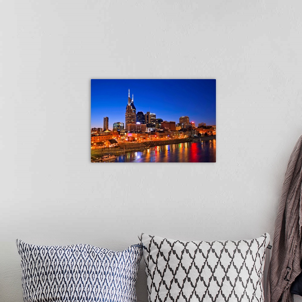 A bohemian room featuring Big, horizontal photograph of the Nashville Tennessee skyline, lit up during blue hour, just afte...