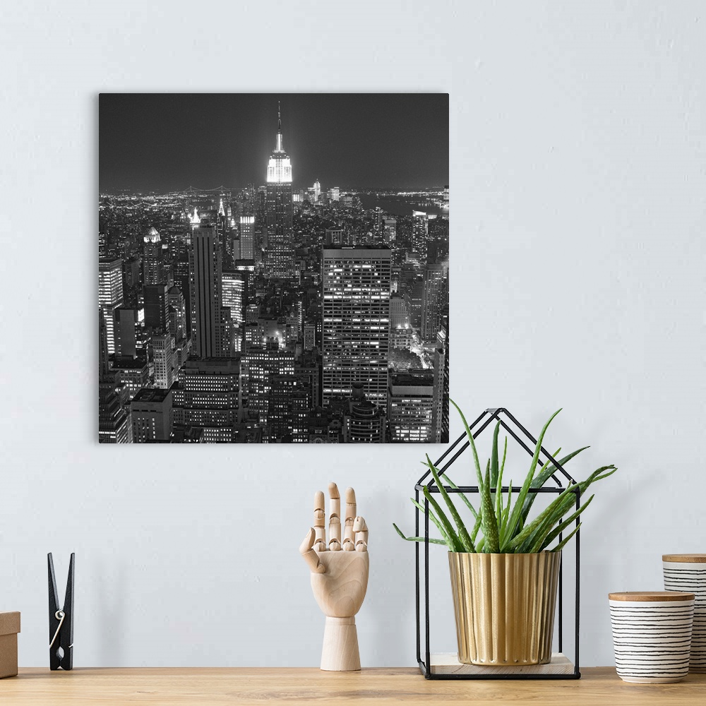 A bohemian room featuring Photograph of skyscrapers and skyline lit up after dark in the "Big Apple."