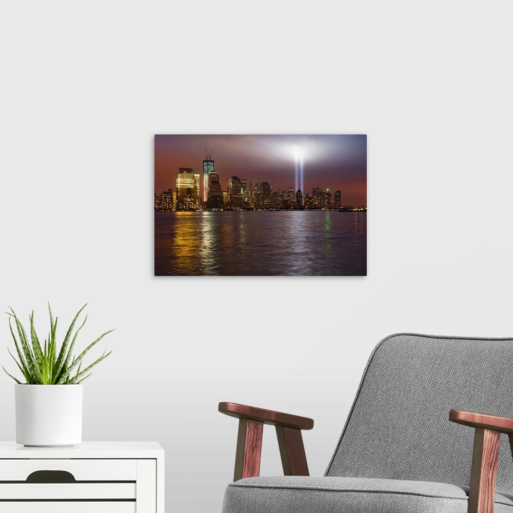 A modern room featuring Large, horizontal photograph of New York City, the Manhattan skyline at night, with 9/11 memorial...