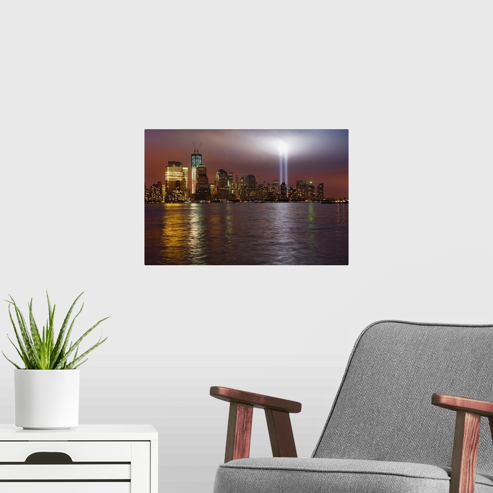 A modern room featuring Large, horizontal photograph of New York City, the Manhattan skyline at night, with 9/11 memorial...