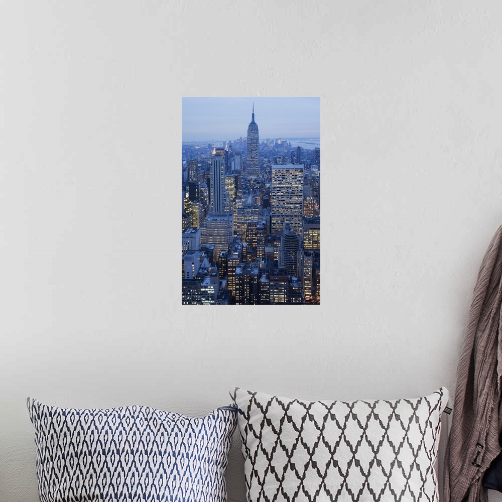 A bohemian room featuring Large vertical photograph of NYC taken at dusk with the Empire State Buiding center and many othe...
