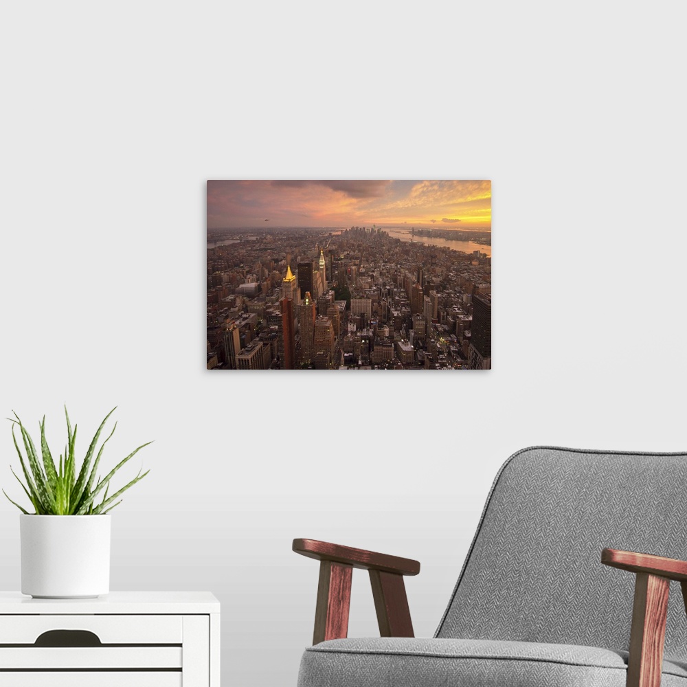 A modern room featuring New York City of Manhattan at Sundown with beautiful clouds.