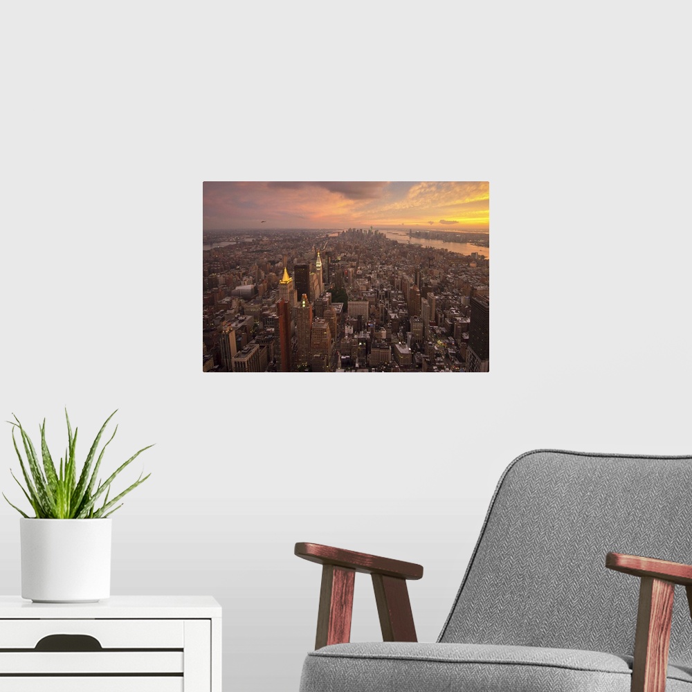A modern room featuring New York City of Manhattan at Sundown with beautiful clouds.