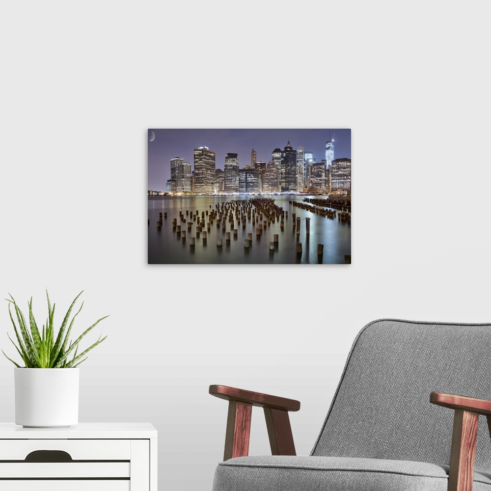 A modern room featuring This is the beautiful New York skyline at night as seen from Brooklyn park