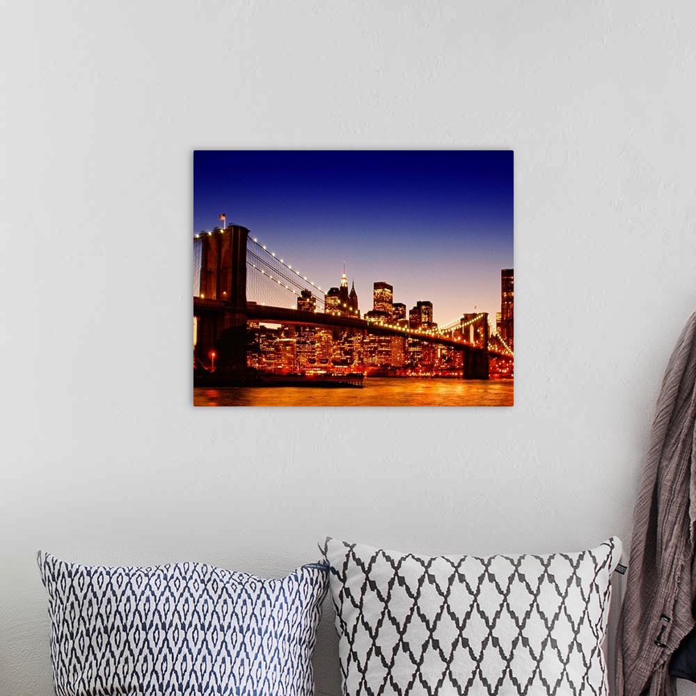 A bohemian room featuring Large photograph of the Brooklyn bridge with a sun kissed river below at dusk with NYC lit up in ...