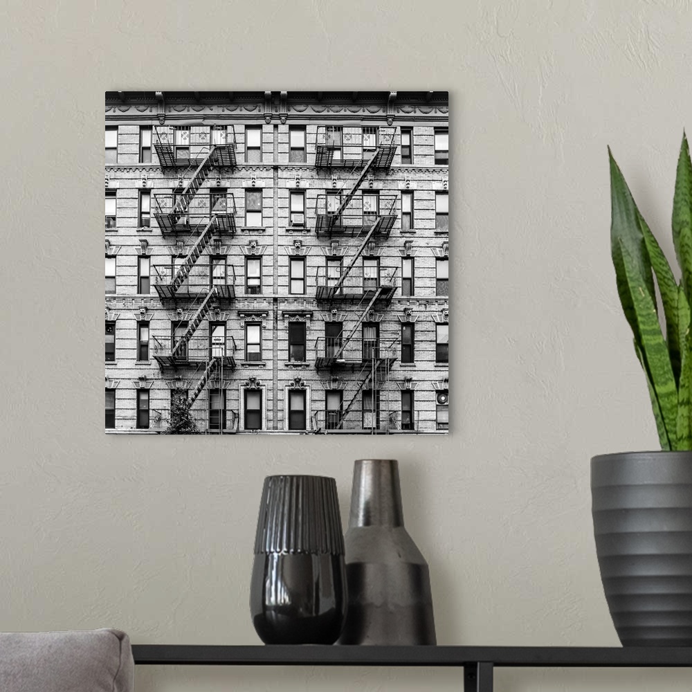 A modern room featuring A fire escape of an apartment building in New York city. Graphic black and white image.