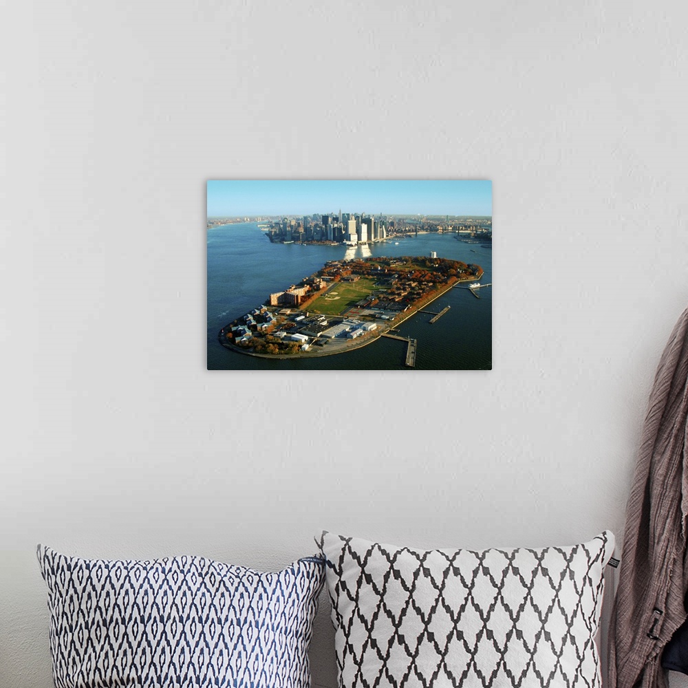 A bohemian room featuring New York Harbor and Manhattan  with Governors Island in the foreground.