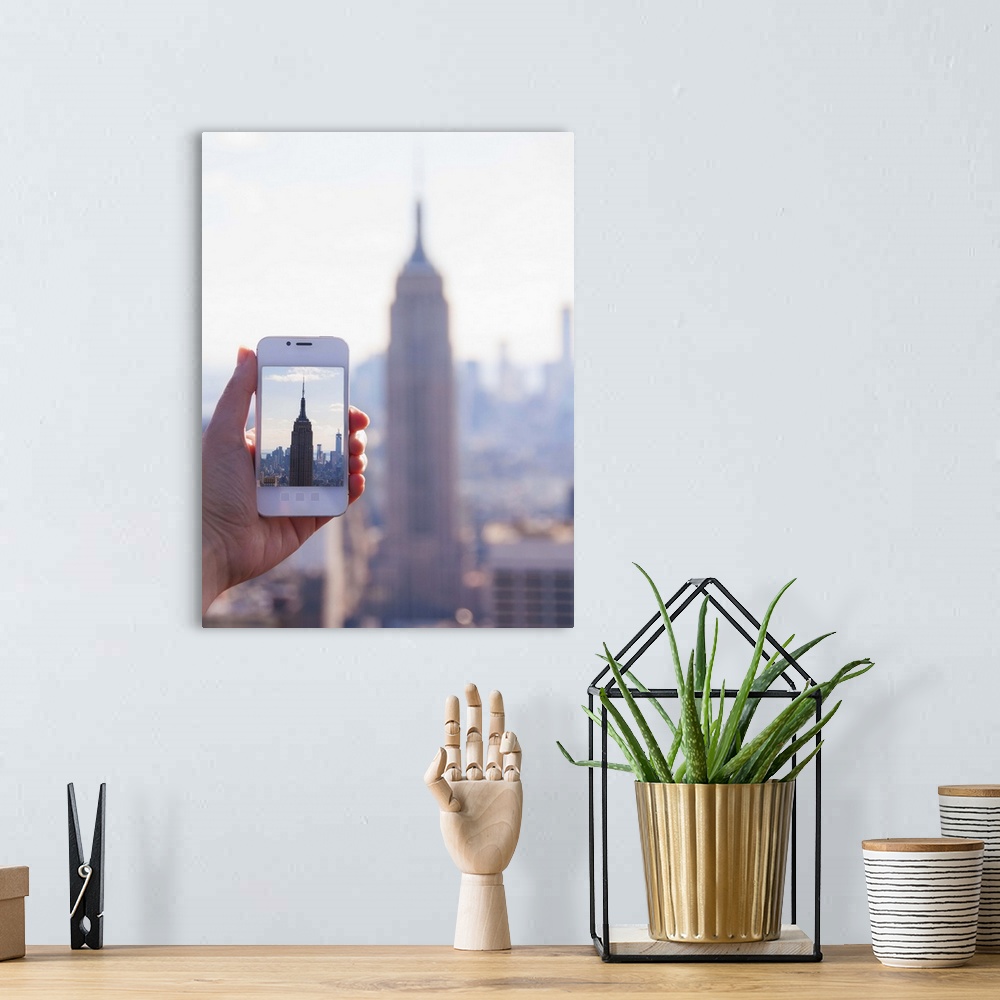 A bohemian room featuring USA, New York State, New York City, Manhattan, Tourist taking photo of Empire State Building