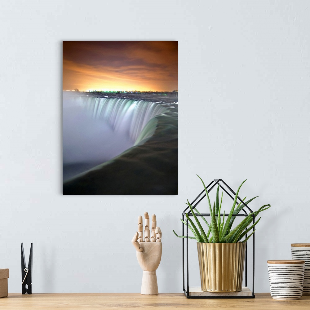 A bohemian room featuring This vertical photograph captures the growing light in the eastern horizon and the massive cascad...