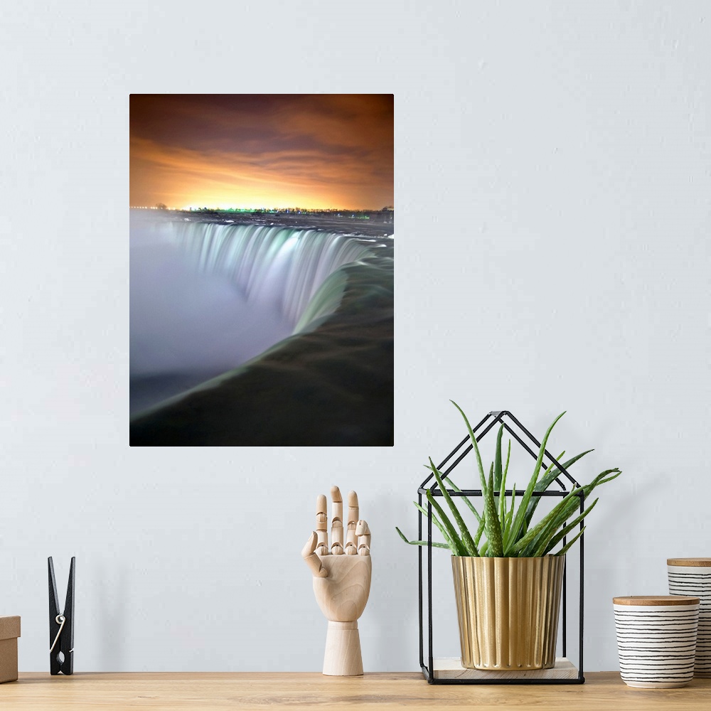 A bohemian room featuring This vertical photograph captures the growing light in the eastern horizon and the massive cascad...
