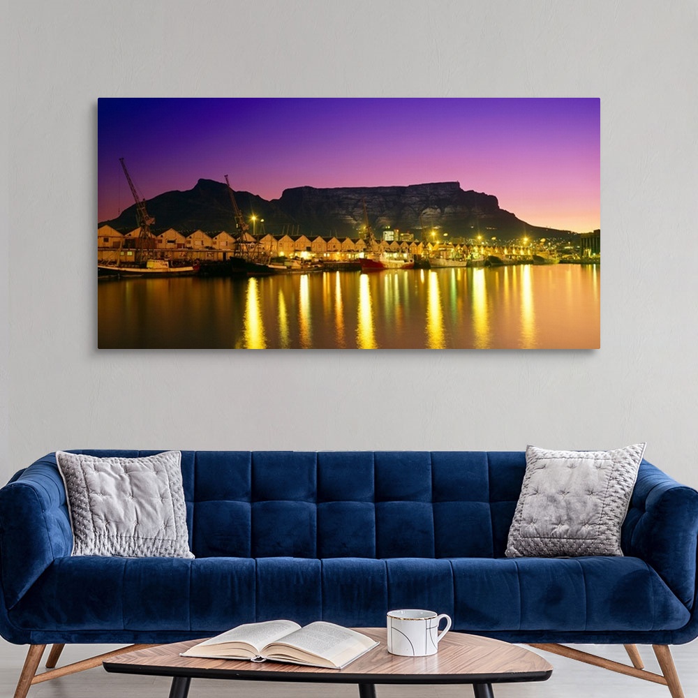 A modern room featuring Night lights of Cape Town Harbour at sunset. V