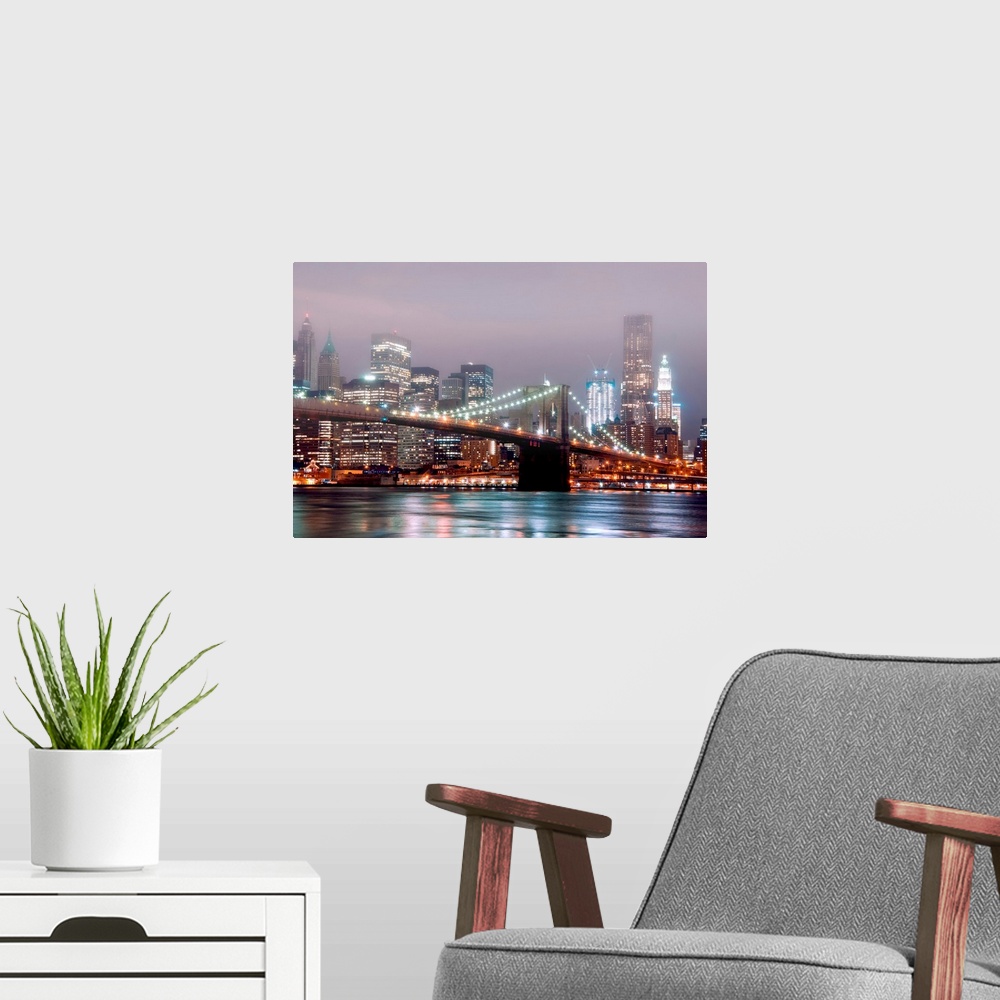 A modern room featuring A misty night scene illuminated by urban lights of downtown Manhattan photographed from the Brook...
