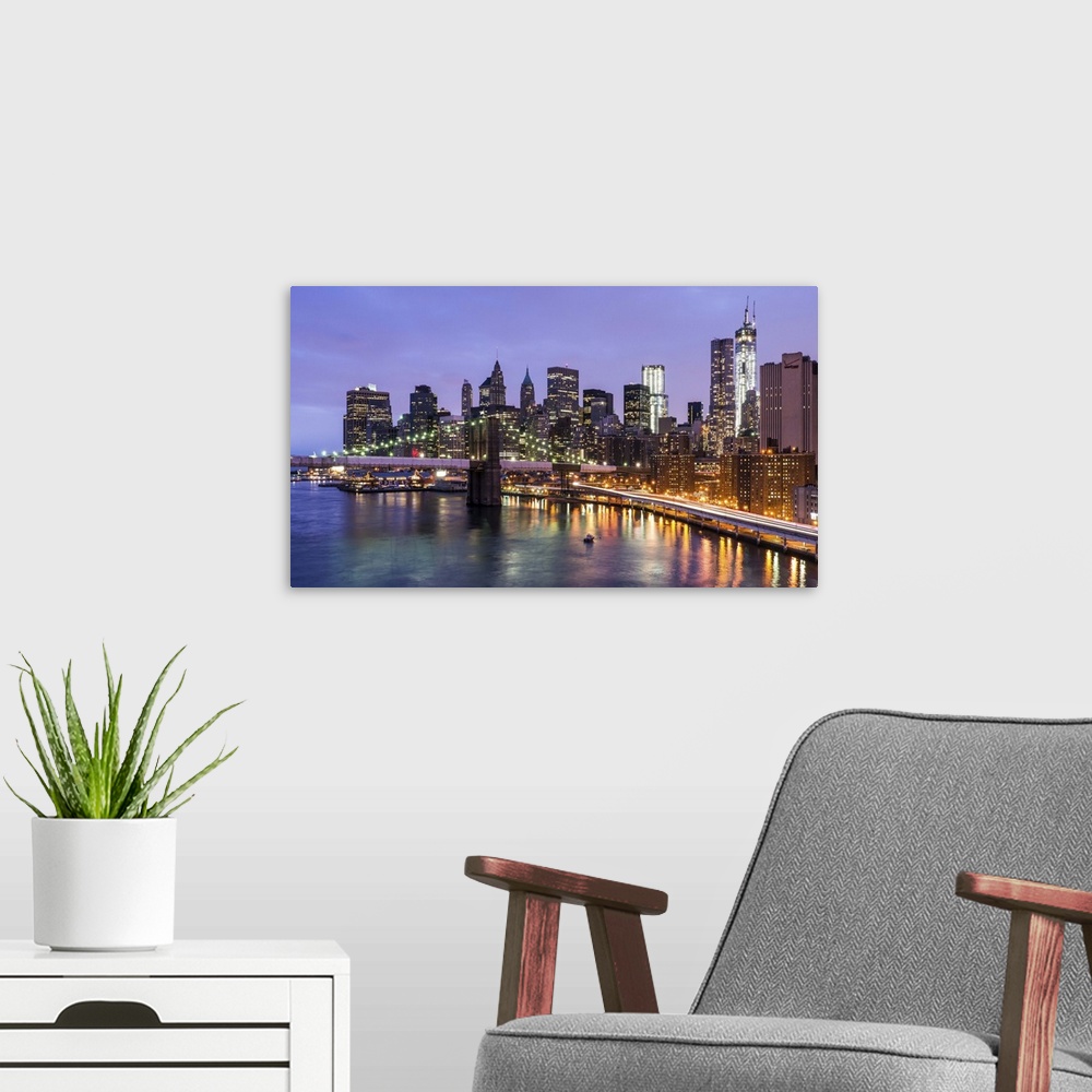 A modern room featuring Blue hour view of Brooklyn Bridge and Lower Manhattan as seen from the Manhattan Bridge. A touch ...