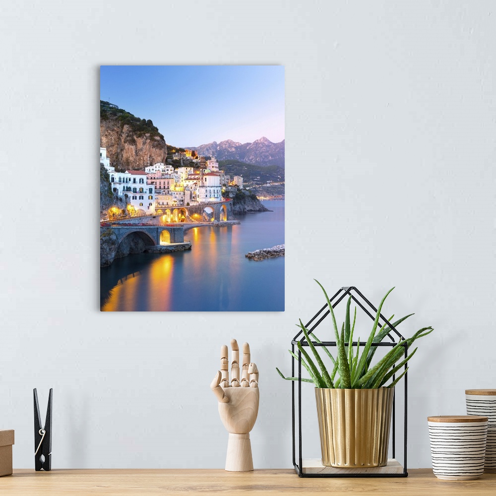 A bohemian room featuring Night view of Amalfi cityscape on coast line of Mediterranean sea, Italy.