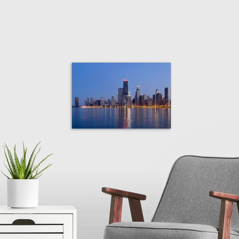 A modern room featuring Northern section of the downtown Chicago skyline at dusk.