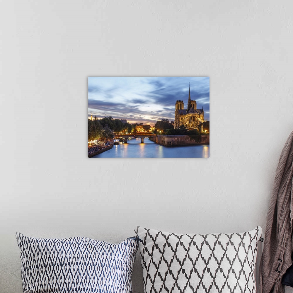 A bohemian room featuring View of Notre Dame and Seine river at dusk in Paris.