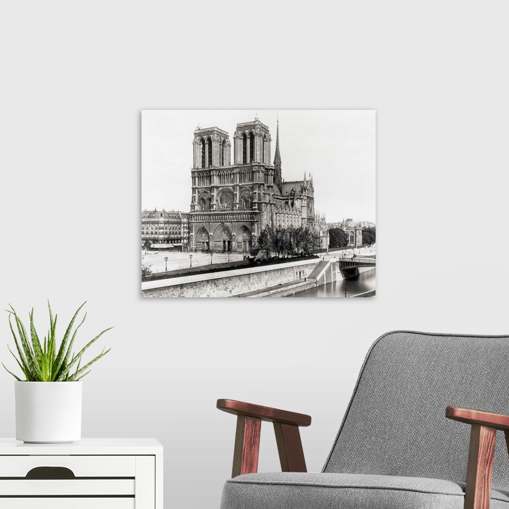 A modern room featuring Paris, France: Side view of Notre Dame Cathedral from the opposite bank of the Seine. Undated pho...