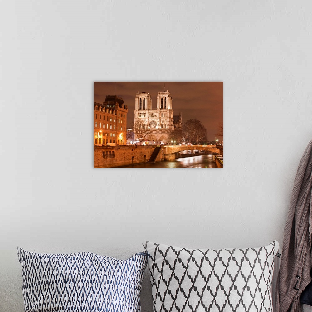 A bohemian room featuring Notre Dame de Paris cathedral at night.