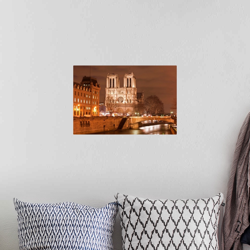 A bohemian room featuring Notre Dame de Paris cathedral at night.