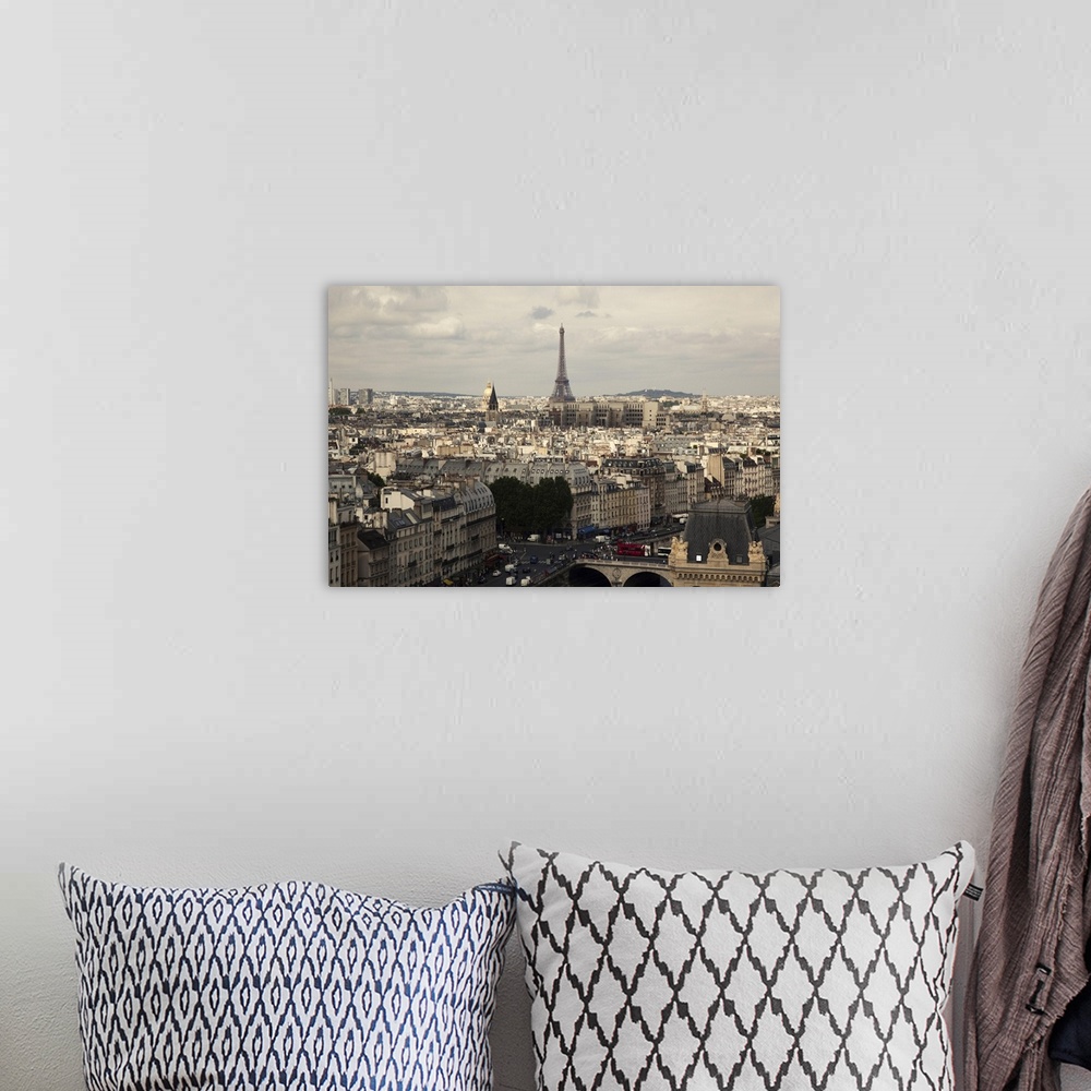 A bohemian room featuring Notre Dame over the Seine towards the Eiffel Tower and rooftops of the city.