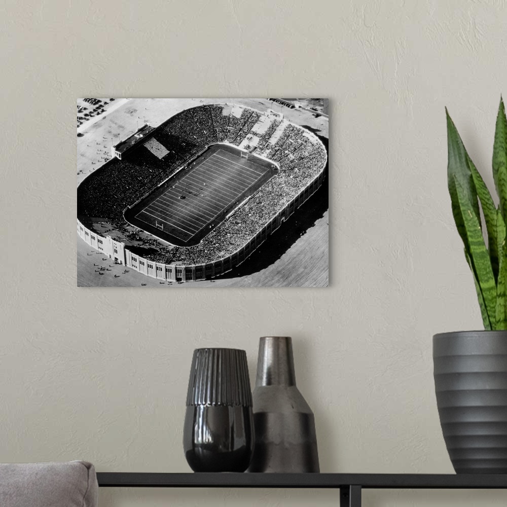 A modern room featuring Aerial view fo Notre Dame Stadium when it was new, during the 1930 Navy game.